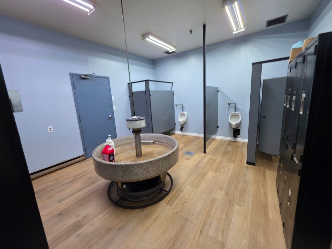 Completed employee locker room with restored partitions and commercial flooring