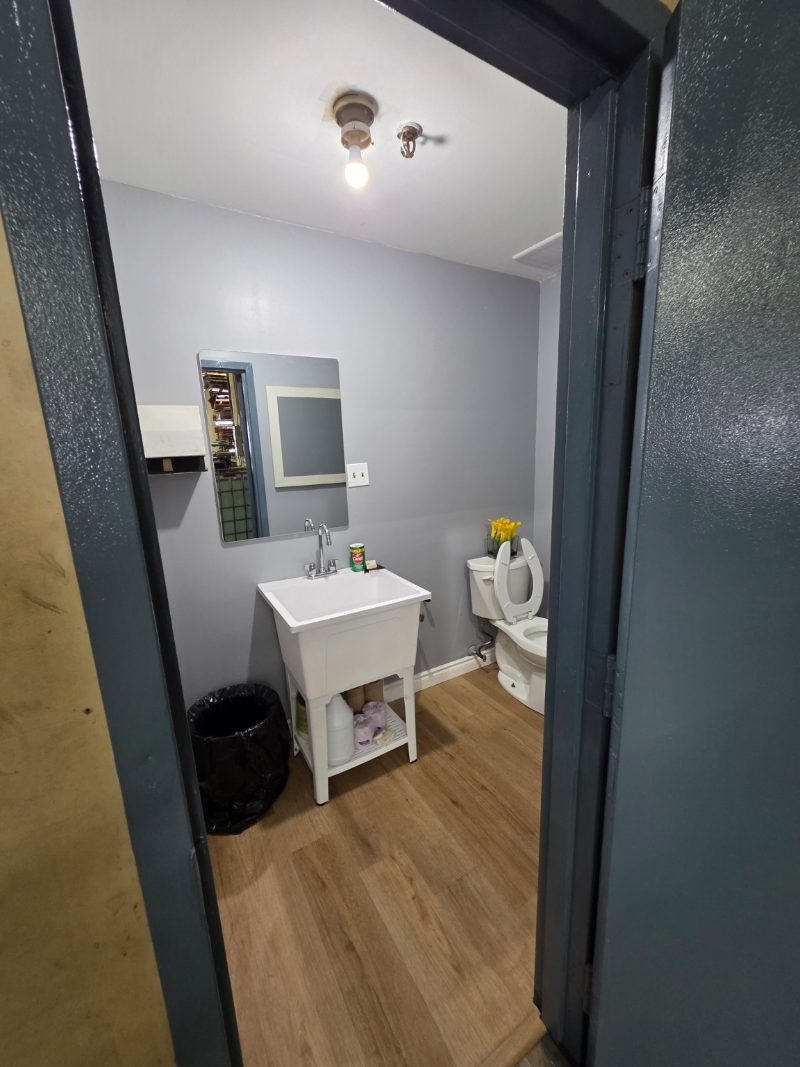 Completed utility washroom with commercial sink and new flooring